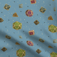 A repeating pattern of a set of 7 Dungeons and Dragons Dice in jewel tones with gold edges, on a medium blue background, surrounded by little yellow stars and small shiny orbs in dark blue. The pattern is demoed on a rippling piece of fabric.