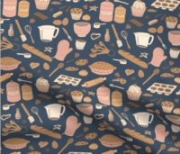 A repeat pattern of baking elements, like cupcakes, pies, cookies, bread, whisks, rolling pins, measuring spoons, eggs, sprinkles, chocolate, flour and sugar in a cute cartoon style, in a pink, orange, and beige color palette on a blue background. The pattern is demoed on a piece of rippling fabric.