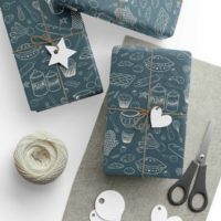 Navy wrapping paper with a repeat pattern of baking elements, like cupcakes, pies, cookies, whisks, rolling pins, measuring spoons, sprinkles, flour and sugar outlined in a cartoon style, in beige. It is on presents wrapped in brown twine.