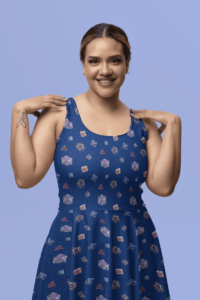 A repeating pattern of 7 Dungeons and Dragons Dice in Bisexual Pride Flag colors: Blue, Magenta, and Purple, on a dark blue background. It is on an asymmetrical sleeveless skater dress with a scoop neck on a cute smiling Latino woman.