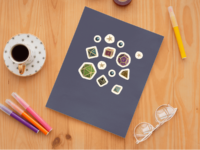 A set of 13 small stickers of the 7 Dungeons and Dragons Dice in a range of rich colors, each with gold trim and numbers, as well as stickers of orbs and stars. The stickers have a white border and are displayed on a dark purple notebook.