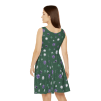 A repeating pattern of 7 Dungeons and Dragons Dice in genderqueer pride flag colors: Purple, white, and green on a dark green background. It is demoed on an asymmetrical sleeveless skater dress with a scoop neck on a white woman shown from behind.