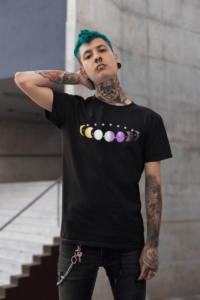 7 phases of the moon in a gradient of the nonbinary pride colors: yellow, white, purple, and black. It is demoed on a Black T-shirt on a gender nonconforming person with turquoise hair and tattoos.