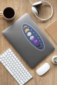 7 phases of the moon in a gradient of the nonbinary pride colors: yellow, white, purple, and black. It is demoed on a large, oval, blue, 10 inches long, with a white border, on the back of a silver laptop.