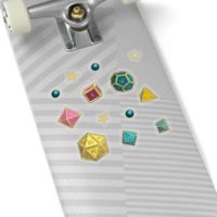 A set of 13 stickers, ranging half an inch to an inch wide, of the 7 Dungeons and Dragons Dice in the colors of the pansexual pride flag: yellow, pink, and turquoise. The stickers are transparent and are on the back of a silver skateboard.