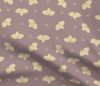 A repeat pattern with yellow clusters of three leaves, their veins outlined clearly in gold. The leaf clusters are lined up in rows with lots of space in between, mirrored horizontally or vertically from the previous one. In between the leaves are little pink star-shaped flowers. The leaves and flowers are done in a paper-cut style on a dark dusty pink background. The pattern is demoed on a piece of rippling fabric.