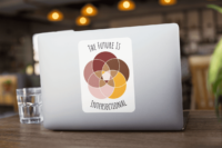 Five interlocking white-bordered circles, arranged in a flower in shades of pink, maroon, brown, and canary yellow, on a white background. Black text above and below says The Future Is Intersectional. It is on a rectangular 6 x 8 in laptop sticker.
