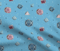 A repeating pattern of a set of 7 Dungeons and Dragons Dice in different shades of the colors from the Transgender Pride Flag: Bright blue, pink, and white, on a light blue background, surrounded by little white stars and small shiny blue orbs. The pattern is demoed on a rippling piece of fabric.