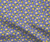 A repeat pattern of lemons, lemon slices, and lemon wedges, interspersed with green leaves, ferns, small dark and light blue flowers. The background is purple with small blue dots. The pattern is demoed in a small size on a piece of rippling fabric.