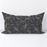 A repeat pattern of stamp art of the veins from a cluster of three leaves, in varying shades of blue, grey, and brown. The clusters of leaves are spaced with only small gaps between them and are facing in all different directions. The stamps are on a dark brown background. The pattern is demoed on a short, narrow lumbar pillow case.
