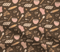 A repeat pattern of baking tools, like rolling pins, oven mitts, muffin tins, measuring and mixing spoons, whisks, spatulas, and cookie cutters, in a cute cartoon style, in a pink, orange, and brown color palette. The pattern is demoed on a piece of rippling fabric.